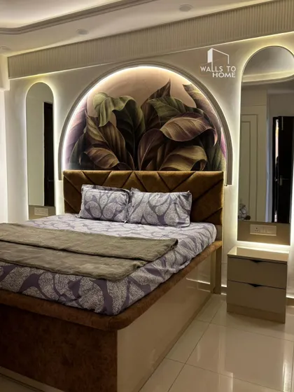 A master bedroom we designed to be a true sanctuary. The arched feature wall with botanical wallpaper, integrated backlit mirrors, and a custom upholstered bed come together to create a cozy, elegant space.