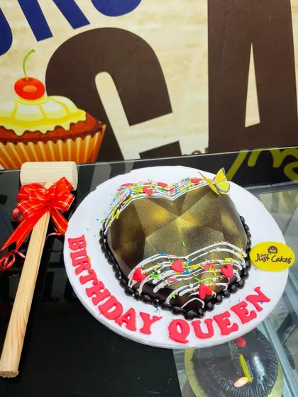 A heart-shaped chocolate piñata cake, complete with a small wooden hammer to smash it open and reveal the treats inside.