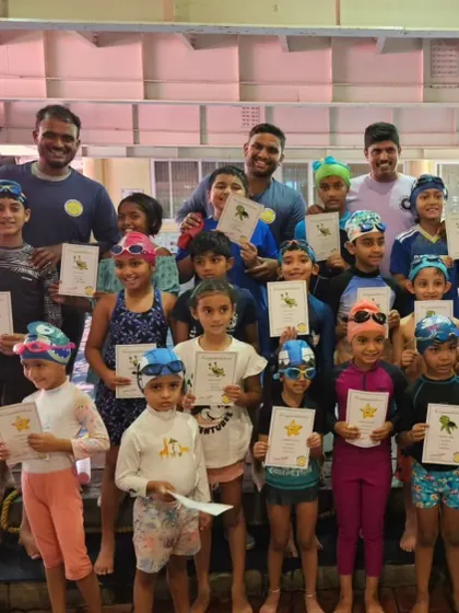 A big group of our Starfish and Turtle level swimmers with their coaches. They've successfully completed their first or second level of our program.