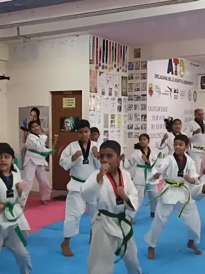 A dynamic shot of a green belt class practicing their forms.