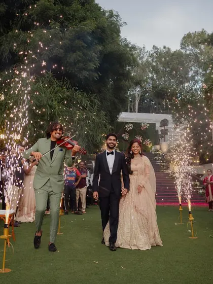 A grand entrance for the couple at their reception, complete with a live violinist and sparkling cold pyrotechnics. It’s these special touches that create truly magical and memorable moments.