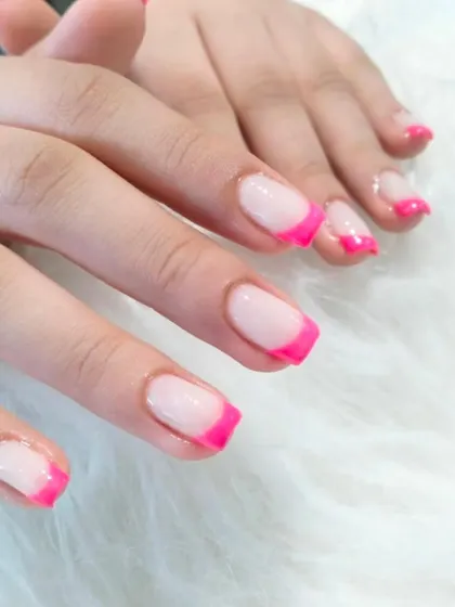 A bright and fun look for shorter nails, these feature a classic shape with a vibrant, hot pink French tip.