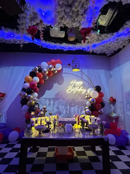 A full view of our 'Smokey Lounge' setup. The checkered floor, cloud-like ceiling, and dramatic lighting create a unique and immersive party environment.