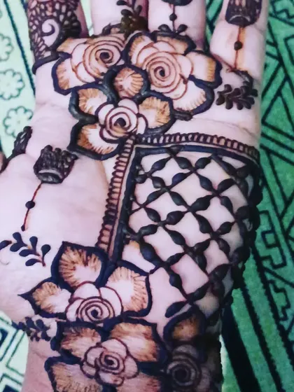 A close-up of a floral design with intricate net-like fillers. I guarantee a dark stain and am now taking bookings for the upcoming wedding season.