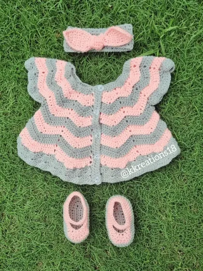 This is one of my favorite creations, a complete baby frock set in soft pink and grey. It includes a chevron-patterned dress, matching little booties, and a sweet bow headband. It’s a perfect, heartfelt gift for a baby shower or a newborn's first outfit.