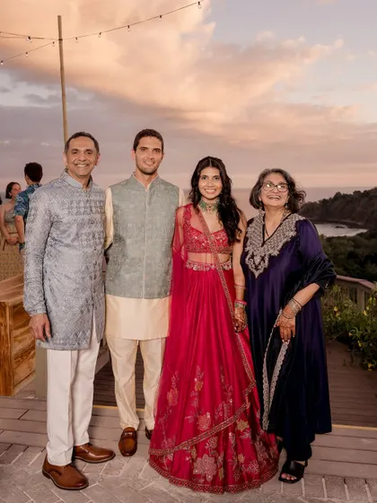 A beautiful family portrait. I also help style the family to ensure everyone's look is coordinated. Here, the couple is pictured with their parents, whose outfits complement the festive Sangeet theme.
