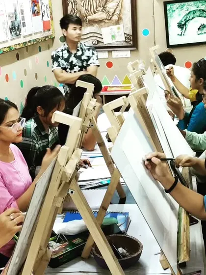 Students learning from an instructor during a pencil drawing class. We provide personalized feedback to help each student improve their technique.