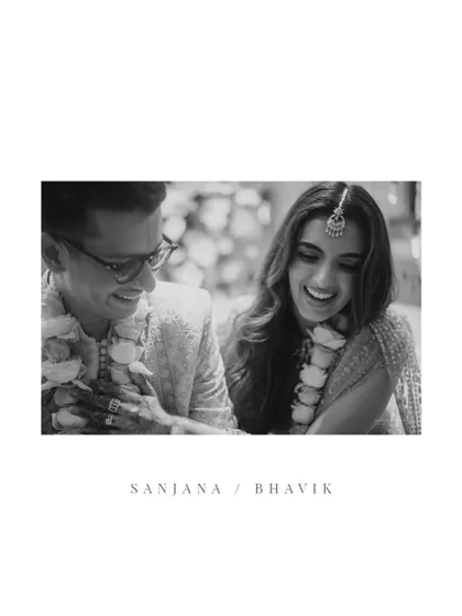 A black and white frame that captures the pure, unadulterated joy and laughter between the couple.