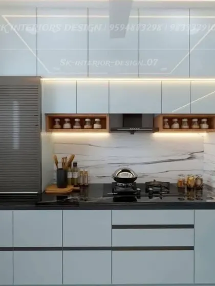A minimalist kitchen with handle-less white cabinets and open wooden niches for spices. The design is clean and functional, with a built-in rolling shutter for appliances.