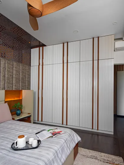 In this bedroom at Sobha Indraprastha, we used fluted white panels with wood-toned inserts for the wardrobe, creating a sense of rhythm and texture. The design combines subtle luxury with fine detailing.