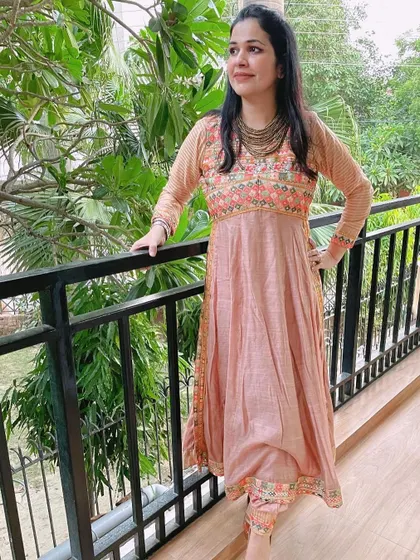 This peach embroidered Anarkali suit is another favorite. The delicate embroidery and soft color make it a very elegant choice for daytime festive events or pujas.