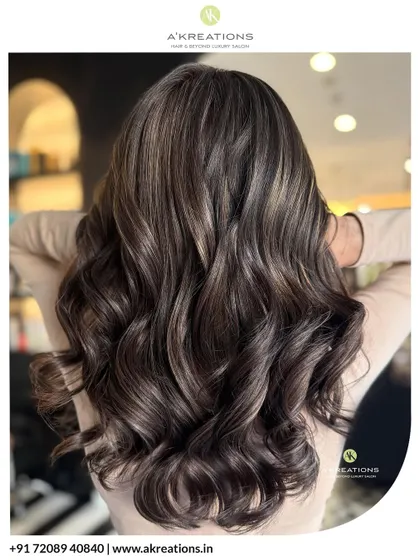 We love cool tones. Here, we created dimensional ash brown highlights, styled into dreamy waves to elevate an everyday look with a touch of salon-fresh sophistication.