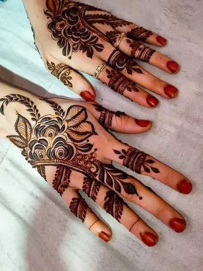 A minimal floral design that focuses on the back of the hand, using negative space to create a light, airy feel.