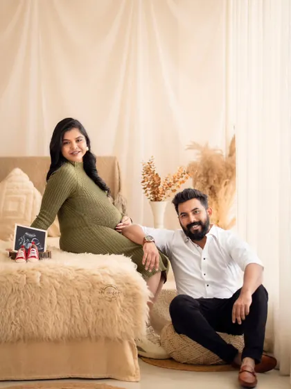A happy family portrait with the couple and their "first baby picture," the sonogram, in our warm and inviting boho studio.