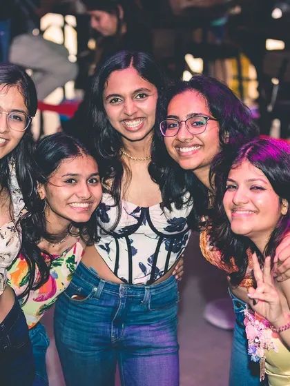 A happy group of friends posing for a picture. The weekend is for making memories with your favorite people.