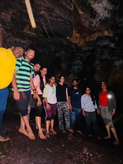 A group photo inside a dark cave, illuminated by our lights. The sense of discovery is amazing.
