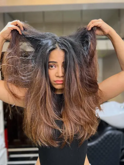 The "before" shot. This client's hair was frizzy and had uneven color, but it was the perfect canvas for a stunning transformation.