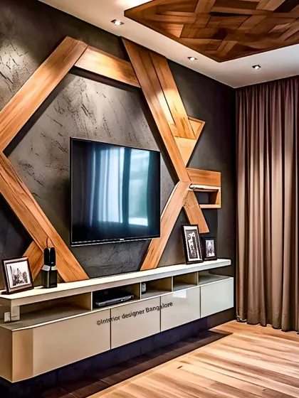 A bold and artistic TV wall design featuring a large, geometric wood frame against a dark textured wall. The design includes a floating console and a matching wood-paneled false ceiling.