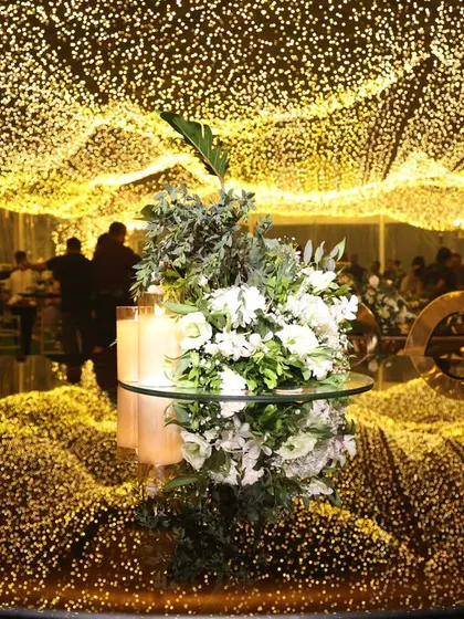 A magical ceiling of fairy lights creating a canopy of stars. This lighting installation completely transforms a space, enveloping guests in a warm, golden glow and creating a truly enchanting atmosphere.