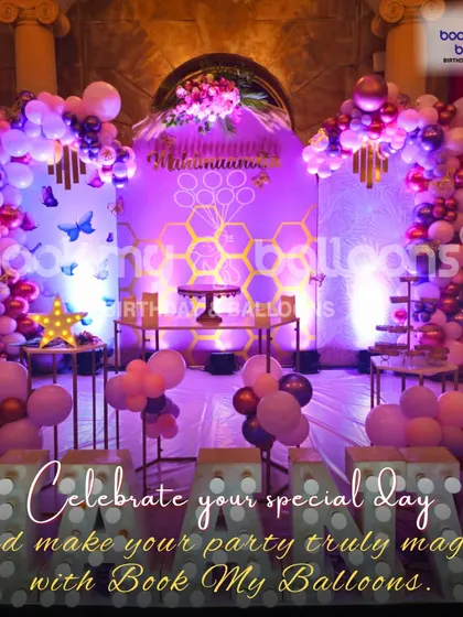 This image from a butterfly themed party shows how we can make your special day truly magical. The elaborate stage with purple lighting and beautiful balloon arches creates an enchanting atmosphere.
