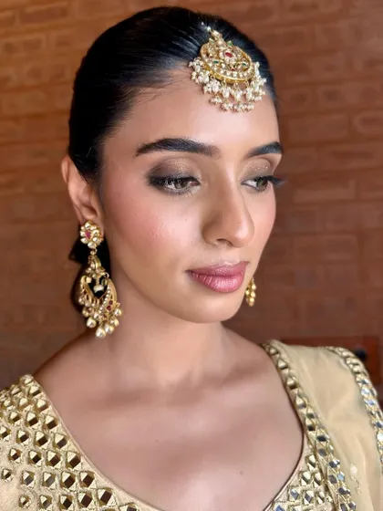 A close-up of the softly smoked-out eyes and radiant skin, a perfect combination for an evening Sangeet celebration.