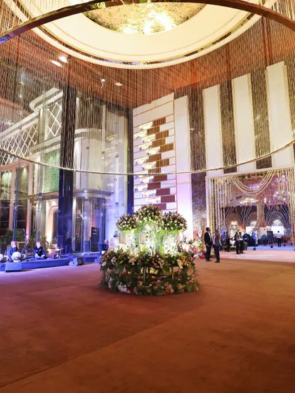 The grand entrance to one of the prestigious events we catered. The magnificent floral arrangements and towering glass elevators set a tone of luxury that we carried through into every aspect of our hospitality.