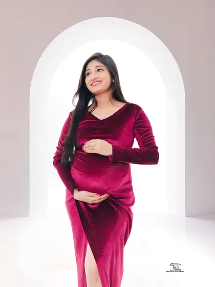 A hopeful portrait of the mother-to-be looking upwards. Her pose and expression convey a sense of dreaming about the future, beautifully captured in our minimalist studio.