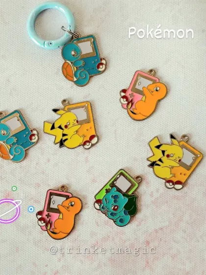 Gotta catch 'em all. These Pokémon enamel charms feature Pikachu, Charmander, Bulbasaur, and Squirtle on mini Game Boy-style backgrounds. A must-have for any Pokémon trainer.
