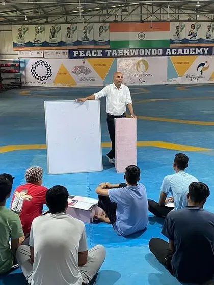 Our coach uses a whiteboard to illustrate a point during the rules workshop. Visual aids and clear explanations make complex topics easy for our athletes to understand.