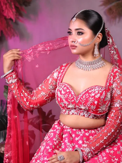 The full bridal attire in all its glory. This image showcases the beautiful pink lehenga and how the makeup look ties everything together.
