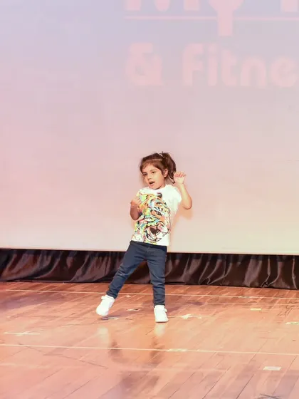 Dea owning the stage with her confident moves. Our training helps kids feel comfortable and expressive in front of an audience.