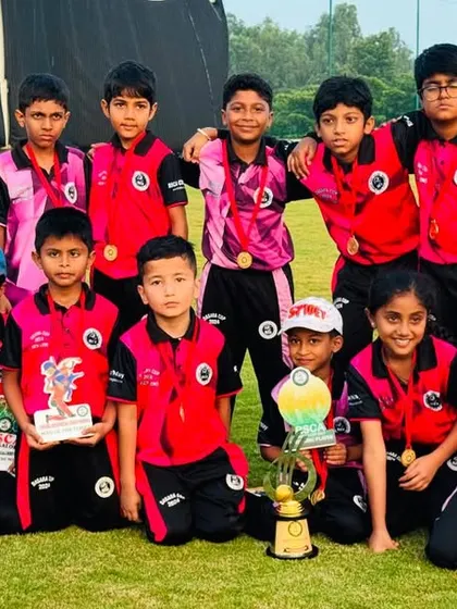 A full squad photo of a junior team with all their awards from a recent tournament.