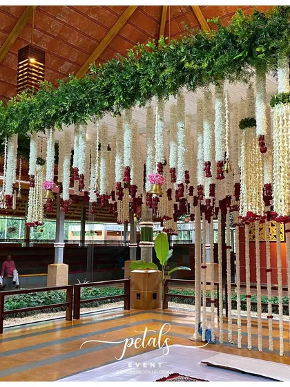 Another angle of the floral streamer backdrop, showing its scale and the beautiful interplay of light and shadow. The greenery on top adds a fresh, natural contrast.
