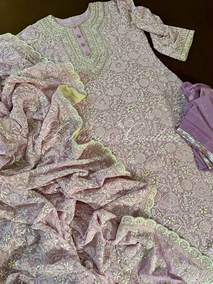 Our hand-embroidered Chikankari Anarkali in a delicate lilac hue. This pure georgette piece features a heavy, all-over jaal work, perfect for sophisticated festive wear.