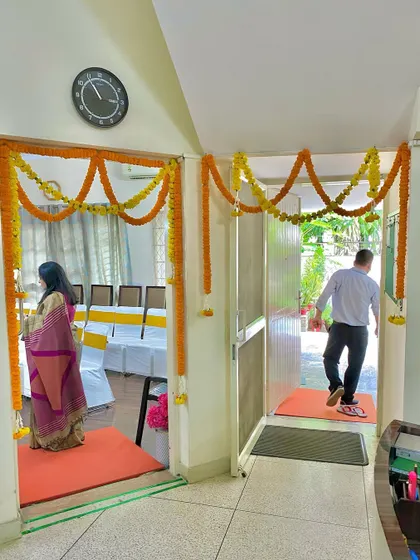 This shows simple and elegant marigold garlands used to decorate the entrances to different rooms, creating a welcoming path for guests during a home function.
