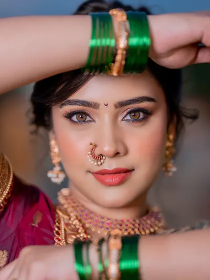 A close-up showcasing the beautiful eye makeup and radiant skin of this Marathi bridal look. The focus is on creating a warm, inviting glow that looks stunning in portraits.