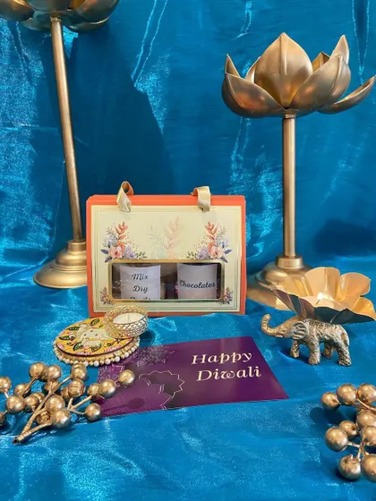 A small and sweet Diwali gesture. This mini carrier box holds two jars of dry fruits or chocolates, making it a perfect token of love for friends and colleagues.