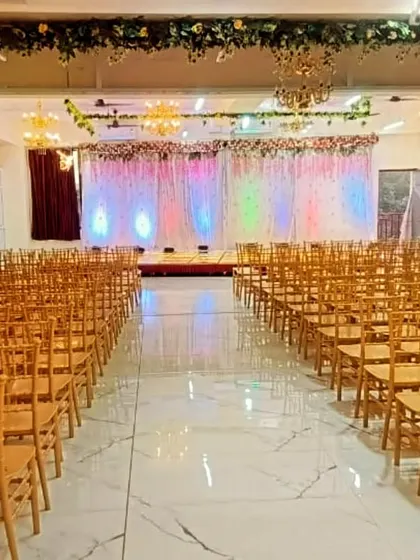 This is our Badlapur hall set up for a large event with theatre-style seating. The clean, spacious area with a decorated stage at the front is perfect for conferences or receptions.