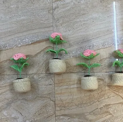 Five beautiful pink multi-petal flower pots, all lined up for a bulk order. The delicate scalloped edge on the pot adds a lovely detail.