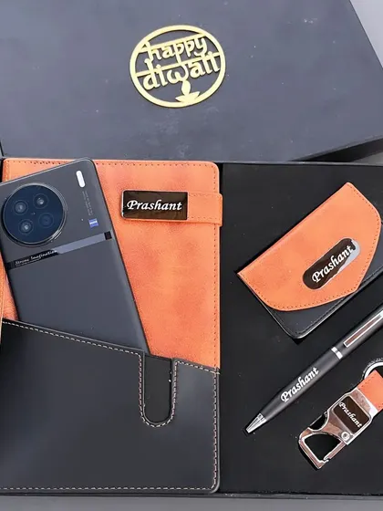 A practical and stylish Diwali gift set for the tech-savvy professional. This combo includes a personalized diary with a phone pocket, a card holder, a pen, and a keychain, all customized for "Prashant".
