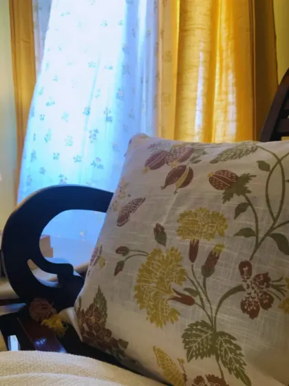 A close-up of our floral cushion cover, with the soft, sun-kissed sheer curtains in the background. It's these small details and combinations that bring a room to life.