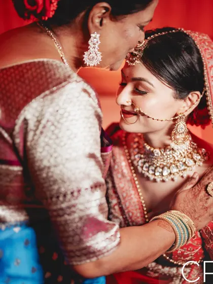 A tender moment between the bride and her mother. These emotional family portraits are a crucial part of the wedding story.