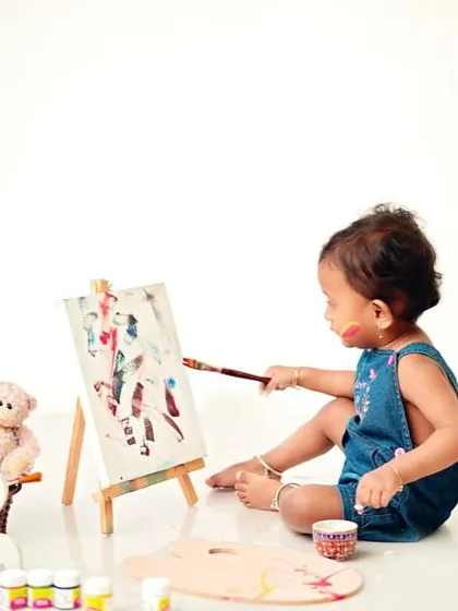 A focused artist, deeply engaged in her work. This theme allows for so many cute and candid shots that showcase your child's developing interests.