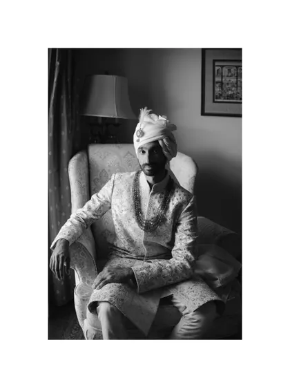A timeless, window-lit portrait of the groom, Sid, in his wedding sherwani. This black and white shot has the feel of a classic painting.