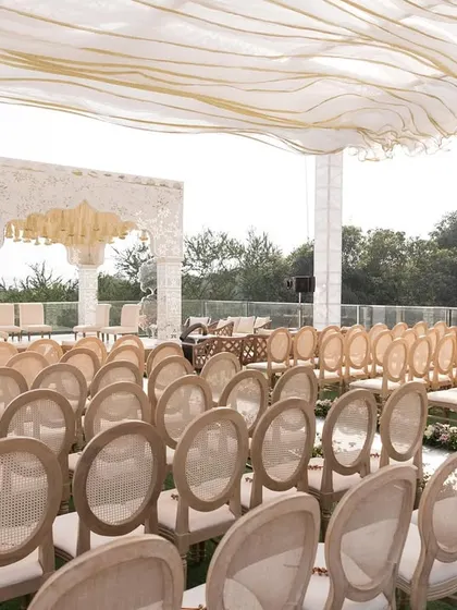 Another angle of the Alibaug wedding setup, showing the clean lines of the seating arrangement and the mirrored aisle leading to the mandap.