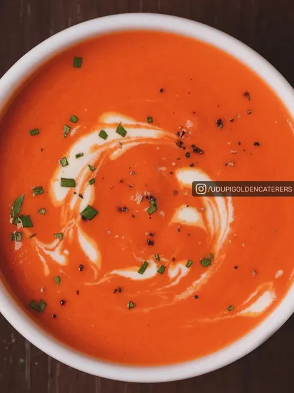 A classic Cream of Tomato soup, rich in flavor and garnished with fresh cream and chives. This timeless soup is a favorite on our catering menu.