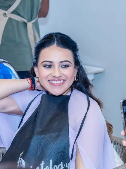 A candid shot from the baby shower activities. Her makeup looks natural and she is having the best time.