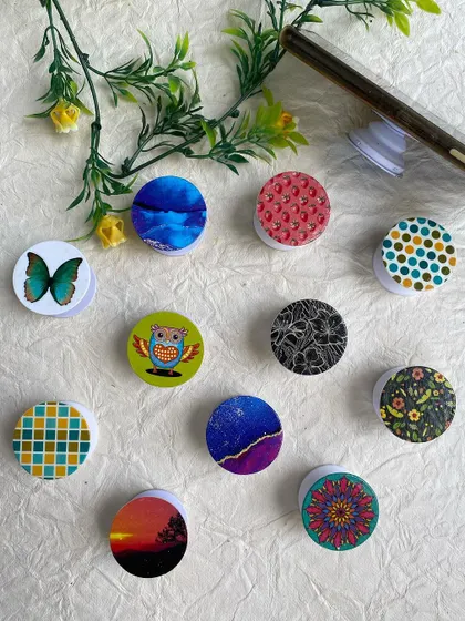 A collection of my colorful, handmade mobile pop sockets. They are an easy way to add some personality to your phone.