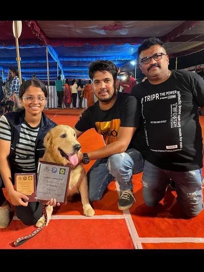 A Golden Retriever and his happy family posing with their awards at the Karavali Dog Show. My training involves the whole family to ensure success.