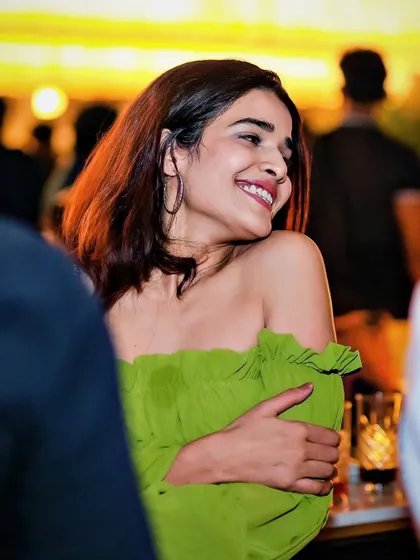 A guest with a radiant smile, enjoying the happy and groovy vibes of the night.
